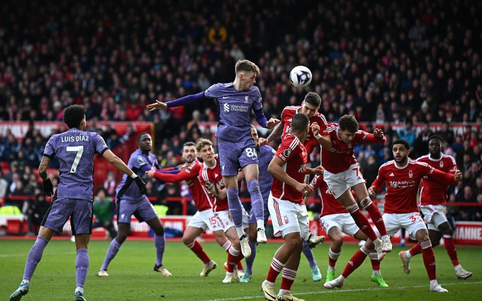 Liverpool's Northern Irish defender #84 Conor Bradley jumps for a header during the English Premier League football match between Nottingham Forest and Liverpool