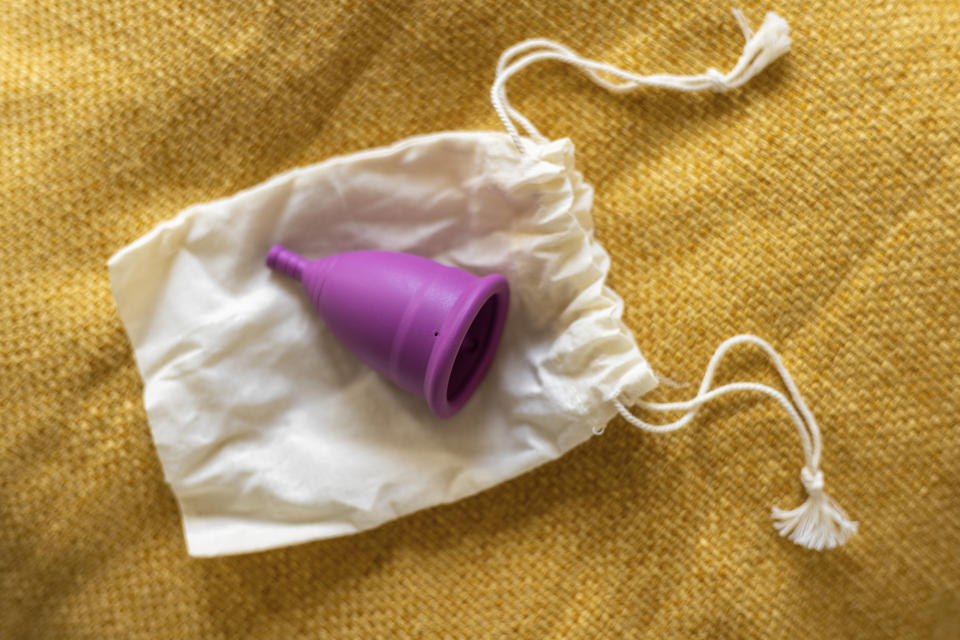 Menstrual cup on a cloth pouch, highlighting an eco-friendly feminine hygiene product