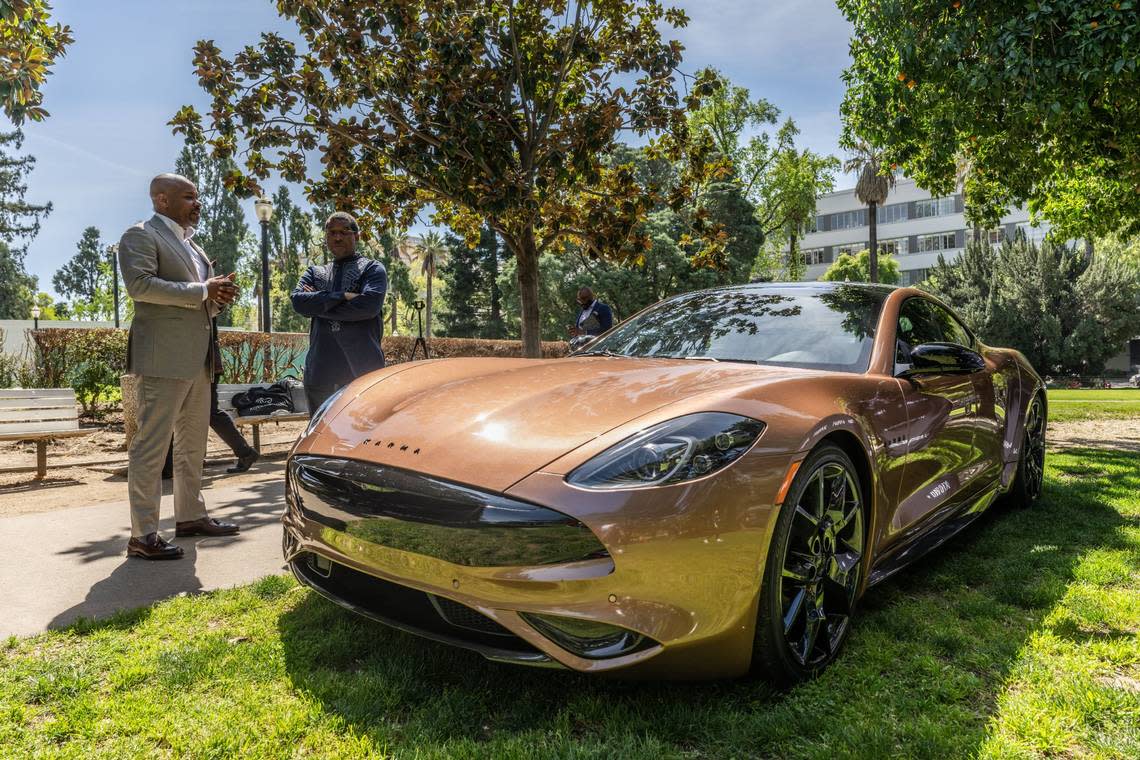 Karma CEO Marques McCammon talks at the Capitol on Wednesday to Assemblyman Corey Jackson, D-Riverside, about Karma Revero, a range-extended luxury electric vehicle manufactured in the legislator’s district. Hector Amezcua/hamezcua@sacbee.com