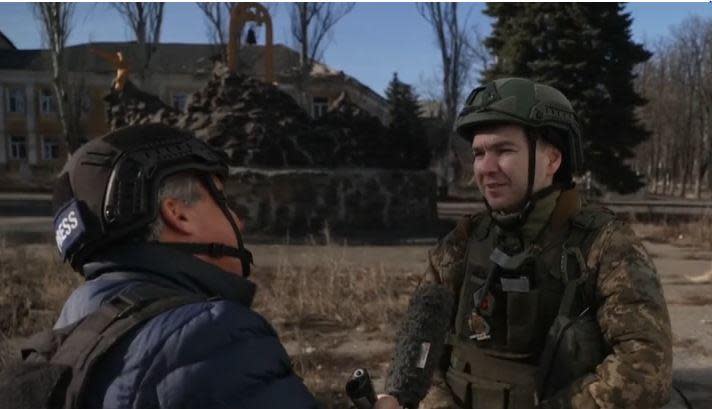 Reuben Sarukhanian, a soldier with Ukraine's 5th Assault Brigade, speaks with CBS News correspondent Charlie D'Agata in Chasiv Yar, eastern Ukraine, in late February 2024. / Credit: CBS News