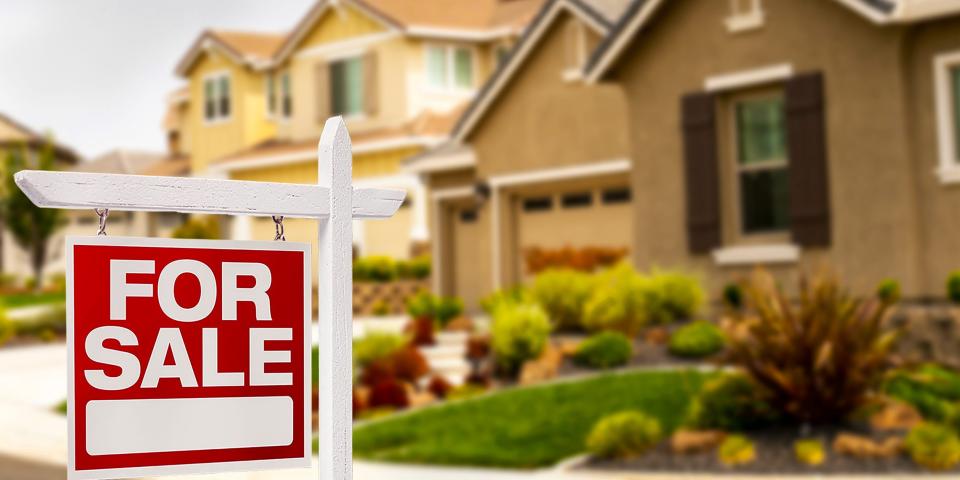 An American home with a for sale sign.