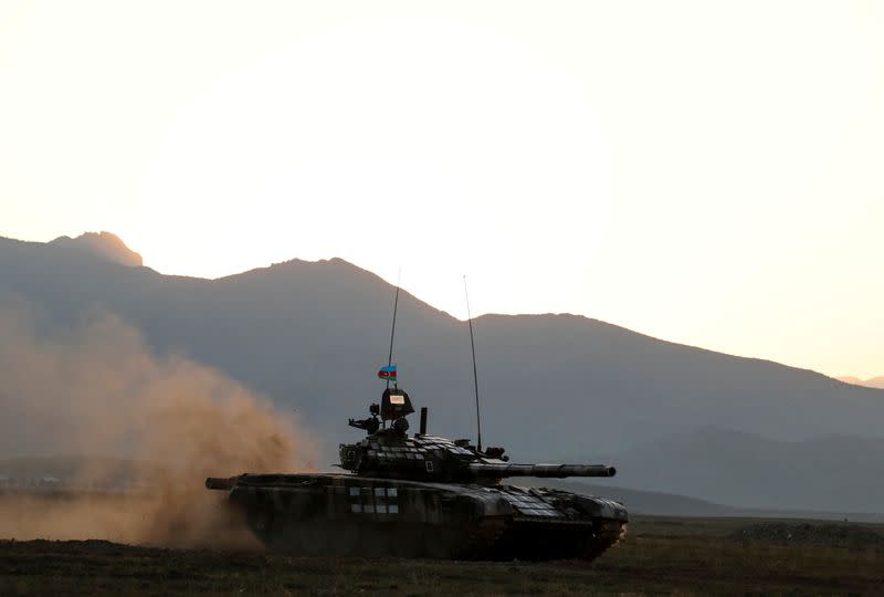 FILE PHOTO: Azerbaijani soldiers maneuver with a tank during a training at a military training and deployment center near the city of Ganja