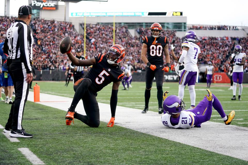 Cincinnati Bengals wide receiver Tee Higgins (5) gestures toward the official after catching a touchdown pass as Minnesota Vikings cornerback Akayleb Evans (21) defends in the fourth quarter of a Week 15 NFL football game between the Minnesota Vikings and the Cincinnati Bengals, Saturday, Dec. 16, 2023, at Paycor Stadium in Cincinnati. The Cincinnati Bengals won 27-24 in overtime.