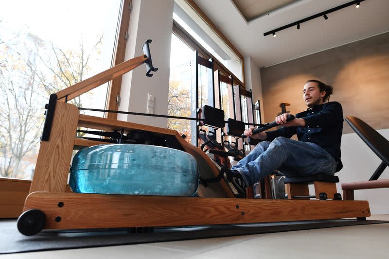 A man tries out a rowing machine in a showroom of U.S. gym equipment manufacturer WaterRower in Munich