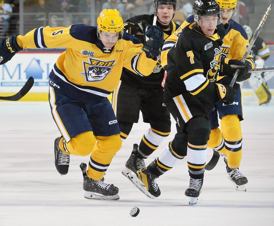 Erie Otters defenseman Nathan Sauder, left, and Sarnia Sting forward Andrew LeBlanc compete for the puck at Erie Insurance Arena in Erie on Saturday.