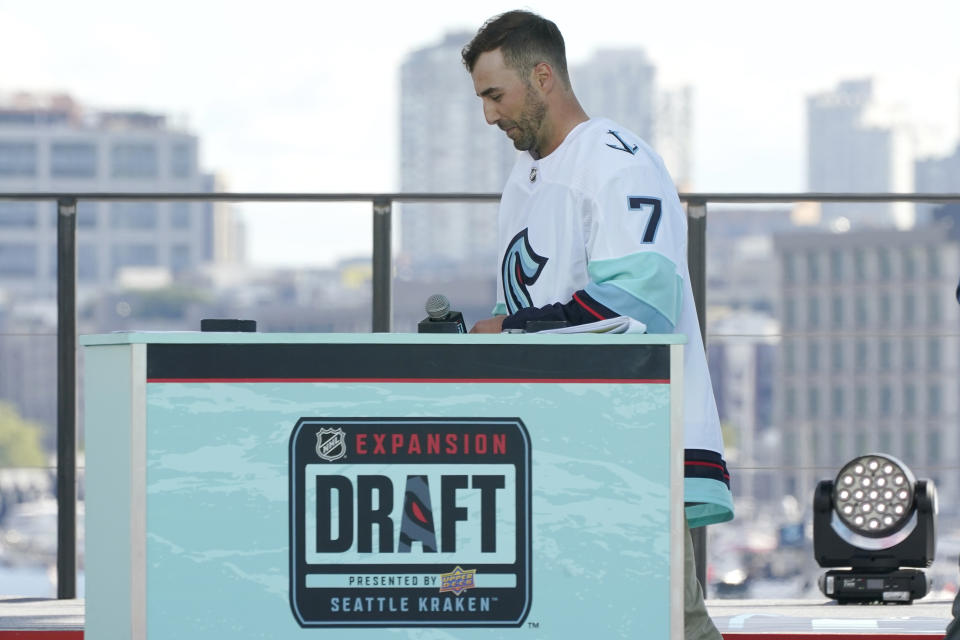 Jordan Eberle, a forward from the New York Islanders, walks off stage after being introduced as a new player for the Seattle Kraken, Wednesday, July 21, 2021, during the Kraken's NHL hockey expansion draft event in Seattle. (AP Photo/Ted S. Warren)