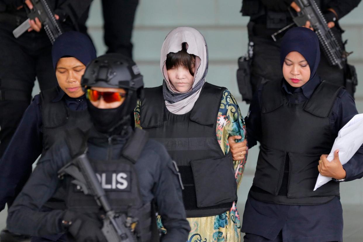 "Conspiracy": Doan Thi Huong is escorted by police as she leaves the court hearing in Malaysia today: AP