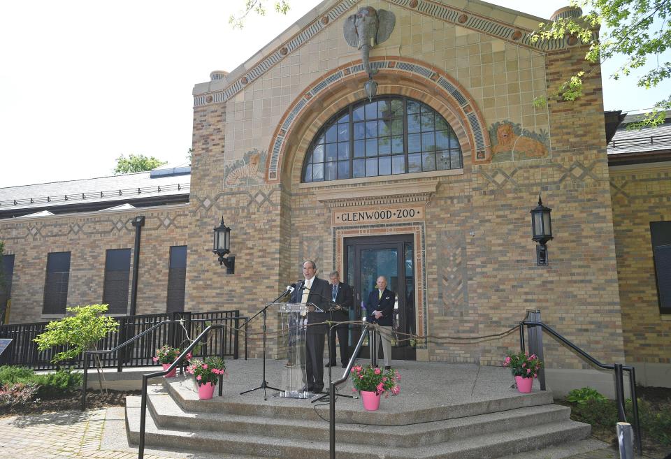 Jeff Beach, at podium, chairman of the Erie Zoo board of directors, is shown on May 25, 2022, at an event celebrating re-opening of the renovated Main Zoo Building.