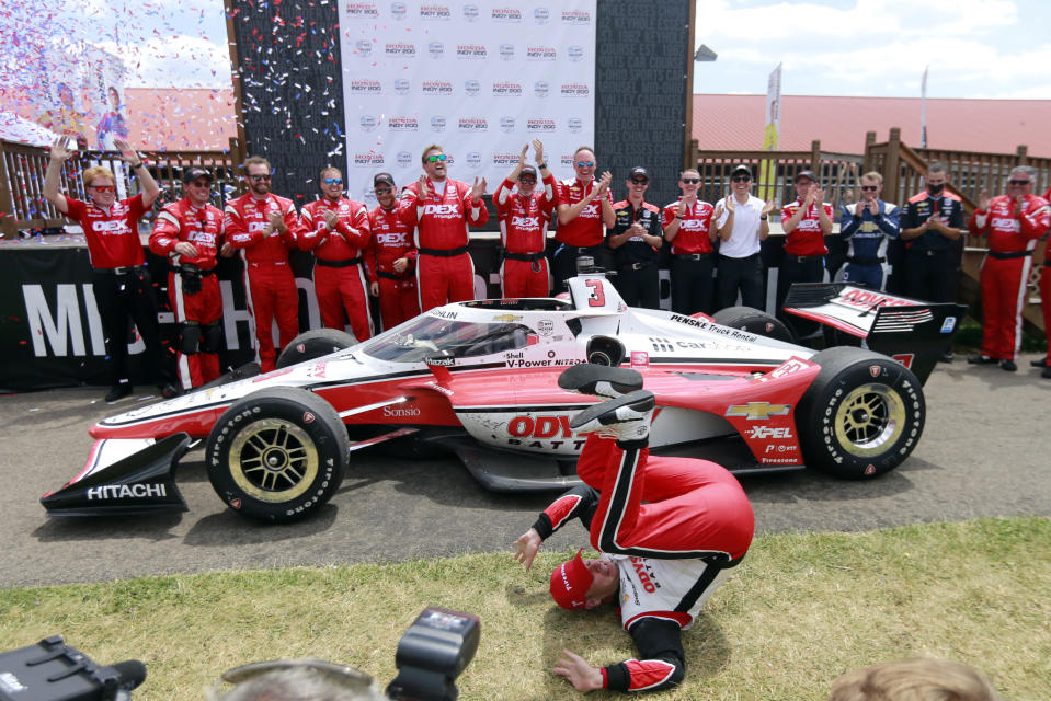 Scott McLaughlin celebrates in Victory Circle after winning an IndyCar auto race at Mid-Ohio Sports Car Course in Lexington, Ohio, Sunday, July 3, 2022. (AP Photo/Tom E. Puskar)