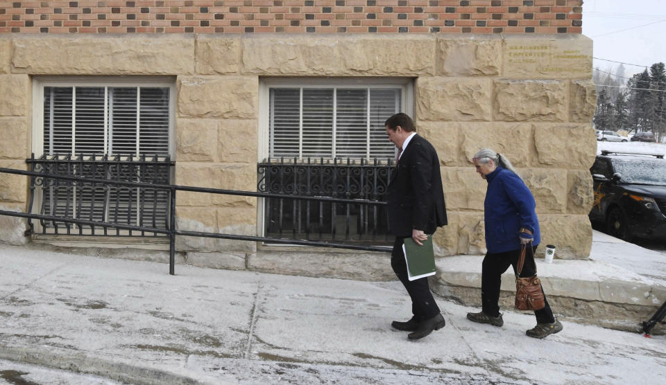 Patrick Frazee's mother, Sheila Frazee, right, heads up the hill to the Teller County Courthouse in Cripple Creek, Colo., Tuesday, Feb. 19, 2019, before Patrick Frazee appeared in court. Patrick Frazee, charged with murder in the death of his missing fiancee Kelsey Berreth, tried to convince a woman he was having an affair with to commit the killing, investigators testified Tuesday. (Jerilee Bennett/The Gazette via AP)