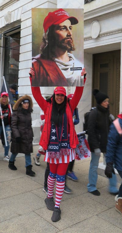 A marcher on Jan. 6, 2021, holds a famous portrait of Jesus by artist Warner Sallman, altered with a red ‘MAGA’ hat supporting Trump. Gregory Starrett, <a href="http://creativecommons.org/licenses/by-nd/4.0/" rel="nofollow noopener" target="_blank" data-ylk="slk:CC BY-ND;elm:context_link;itc:0;sec:content-canvas" class="link ">CC BY-ND</a>