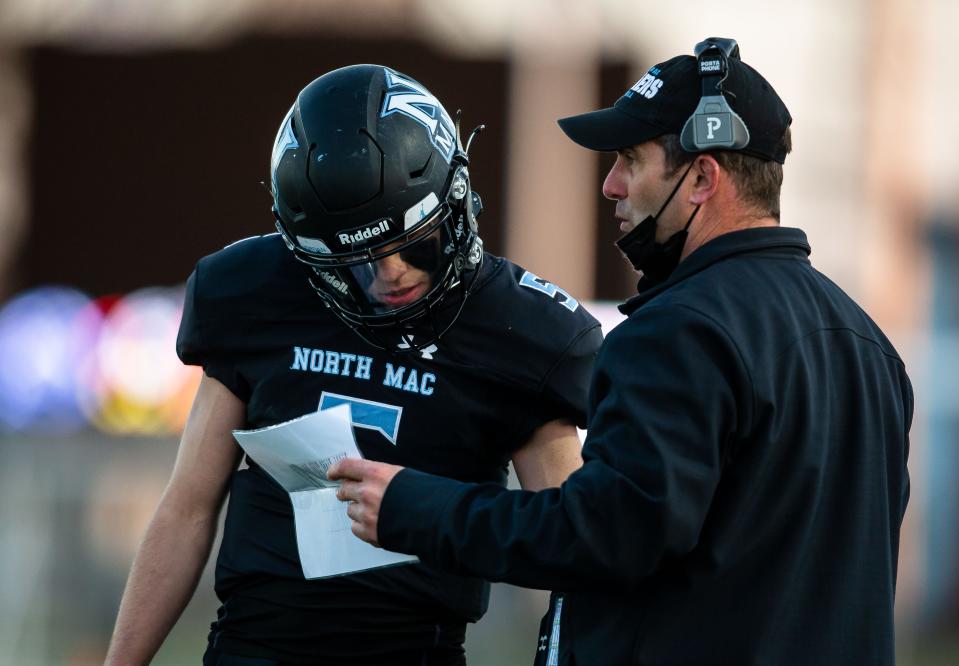 North Mac head football coach Patrick Bowman sends in the play call with North Mac's Kannon Kirk (5) as the Panthers take on Williamsville in the first half at North Mac High School in Virden, Ill., Friday, April 2, 2021. [Justin L. Fowler/The State Journal-Register] 