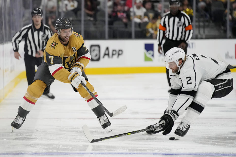 Vegas Golden Knights defenseman Alex Pietrangelo (7) passes around Los Angeles Kings defenseman Alexander Edler (2) during the second period of an NHL preseason hockey game Monday, Sept. 26, 2022, in Las Vegas. (AP Photo/John Locher)