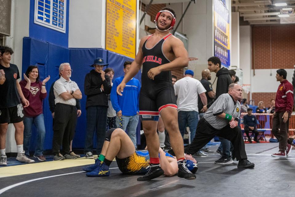 Oak Hills' Charles King celebrates after beating Serrano’s Anthony DeLeon during the 220-pound semifinals at the CIF-Southern Section Inland Division boys wrestling tournament on Saturday, Feb. 11, 2023. King was trailing at the start of the third period and won with a last second take down and pin.
