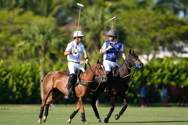 <p>Rebecca Blackwell/AP</p> Prince Harry (right) plays in the Royal Salute Polo Challenge in Florida on April 12, 2024.