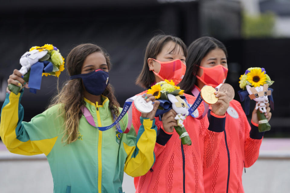 From left, silver medalist Rayssa Leal of Brazil, gold medalist Momiji Nishiya of Japan, center, and bronze medalist Funa Nakayama of Japan show their medals won in the women’s street skateboarding finals at the 2020 Summer Olympics, Monday, July 26, 2021, in Tokyo, Japan. (AP Photo/Ben Curtis)