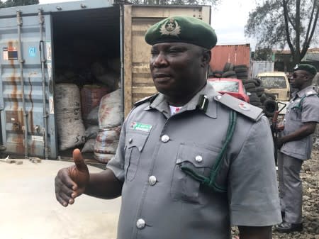 A customs official talks about the seizures of containers with sacks of confiscated pangolin scales, close to Nigeria Customs Service in Ikeja