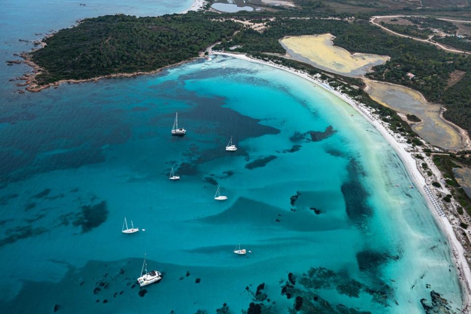 San Teodoro’s coastline is a swirl of bright colours (Renato Granieri/PA)