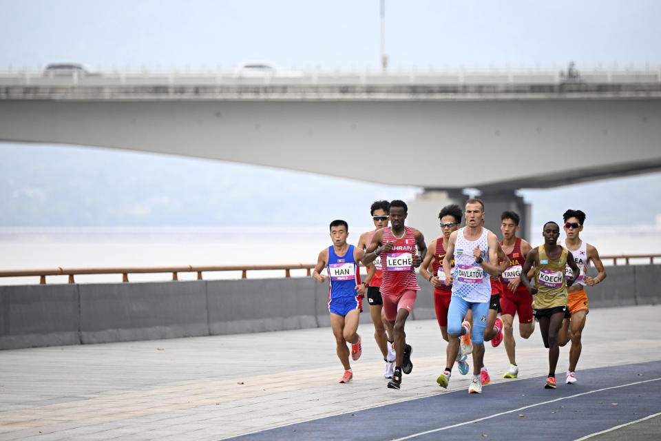 Runners compete during the men's marathon at the 19th Asian Games in Hangzhou, China, Thursday, Oct. 5, 2023. (Song Yanhua/Pool Photo via AP)