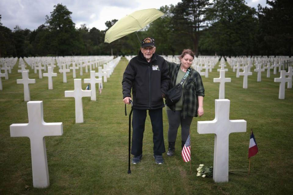 Gene Kleindl, from Rockford, Illinois, stands at the grave of his friend Ralph Gaddis