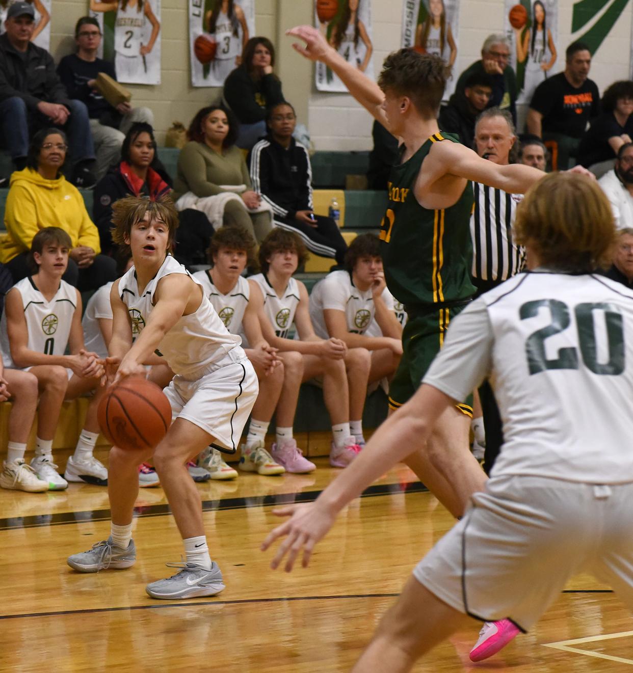 Blake Kuehnlein of St. Mary Catholic Central passes as Flat Rock's Tim Murphy defends Tuesday, Jan. 9, 2024. Flat Rock won the game 50-39.