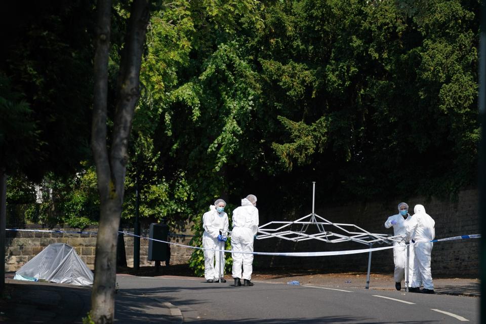 Police forensics officers on Magdala road, Nottingham (PA)