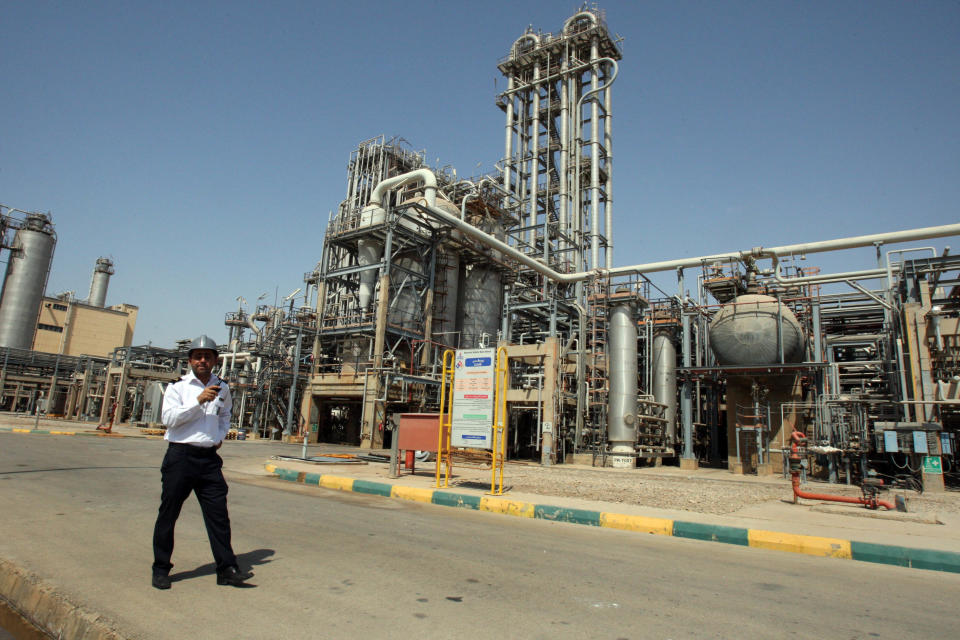 FILE - In this Wednesday, Sept. 28, 2011 file photo, an Iranian security guard stands at the Maroun Petrochemical plant at the Imam Khomeini port, southwestern Iran. Technicians battling a complex computer virus took the ultimate firewall measures shutting off all Internet links to Iran's oil ministry and the terminal that carries nearly all the country's crude exports. (AP Photo/Vahid Salemi, File)