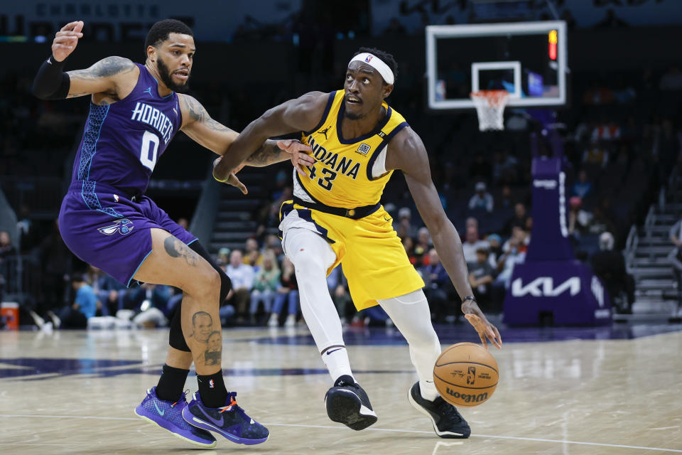 Indiana Pacers forward Pascal Siakam, right, drives against Charlotte Hornets forward Miles Bridges, left, during the second half of an NBA basketball game in Charlotte, N.C., Monday, Feb. 12, 2024. (AP Photo/Nell Redmond)