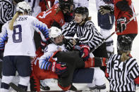 <p>Official Jenni Heikkinen (64), of Finland, tries to separate Kelly Pannek (12), of the United States, and Laura Stacey (7), of Canada, as they scuffle during the third period of a preliminary round during a women’s hockey game at the 2018 Winter Olympics in Gangneung, South Korea, Thursday, Feb. 15, 2018. Canada won 2-1. (AP Photo/Julio Cortez) </p>