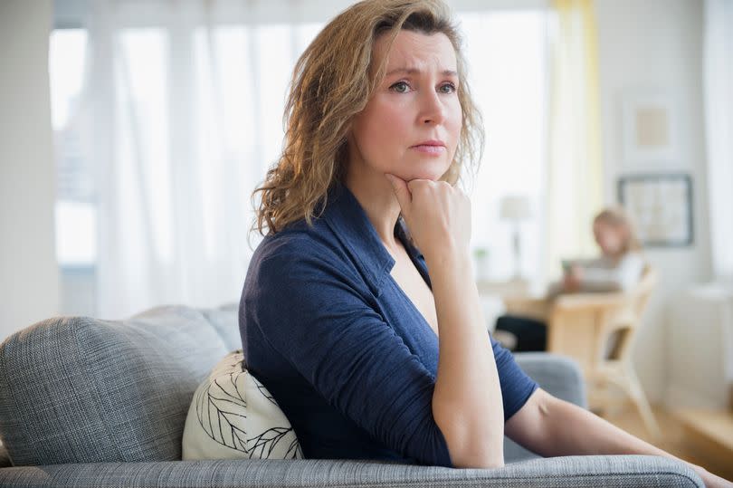 A middle-aged woman looking worried