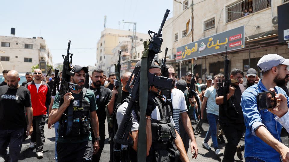 Armed men attended the funeral on Wednesday of the Palestinians killed during the Israeli military operation. - Ammar Awad/Reuters