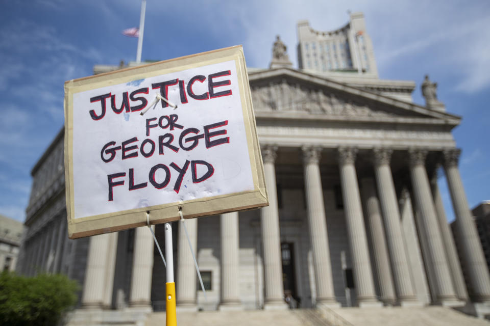 A protester holds a sign in front of New York Supreme Court on May 29 demanding justice for George Floyd, a handcuffed black man who died Memorial Day in Minneapolis police custody. (Photo: ASSOCIATED PRESS/Mary Altaffer)