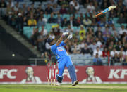 India's MS Dhoni loses control of his bat during a T20 cricket match against Australia in Sydney February 1, 2012. REUTERS/Daniel Munoz (AUSTRALIA - Tags: SPORT CRICKET TPX IMAGES OF THE DAY)