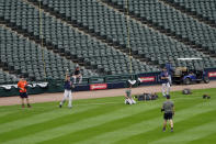 Members of the Houston Astros workout after Game 4 of an ALDS baseball game was postponed due to a forecast of inclement weather Monday, Oct. 11, 2021, in Chicago. The makeup game is scheduled for Tuesday afternoon at Guaranteed Rate Field. (AP Photo/Charles Rex Arbogast)