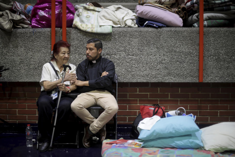 A&nbsp;woman talks with a priest two days after the&nbsp;earthquake in Mexico City, Mexico. The earthquake comes 32 years after a magnitude-8.0 earthquake hit on September 19, 1985.