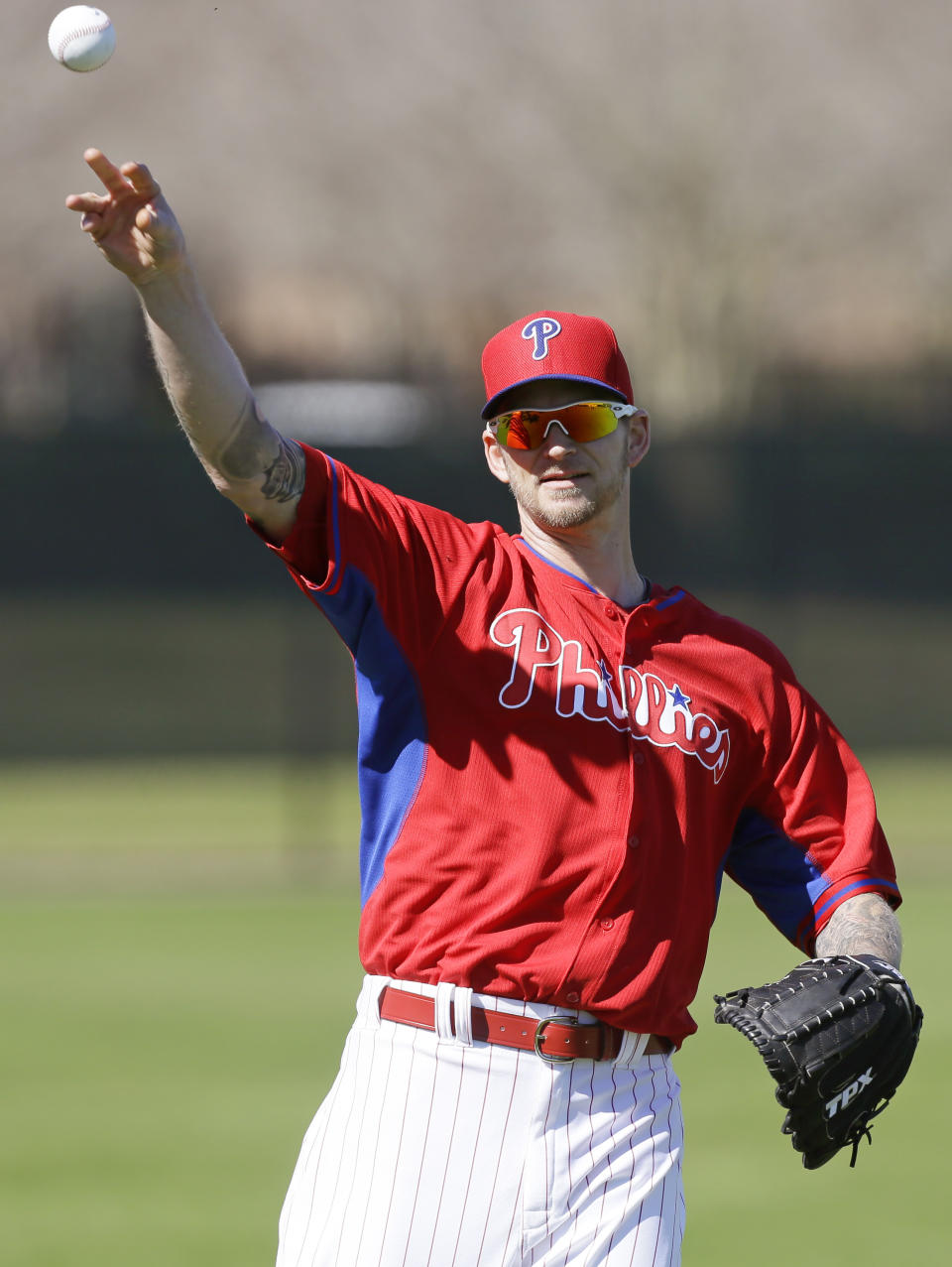 Philadelphia Phillies pitcher A.J. Burnett throws the ball in the outfield during spring training baseball practice on Sunday, Feb. 16, 2014, in Clearwater, Fla. (AP Photo/Charlie Neibergall)