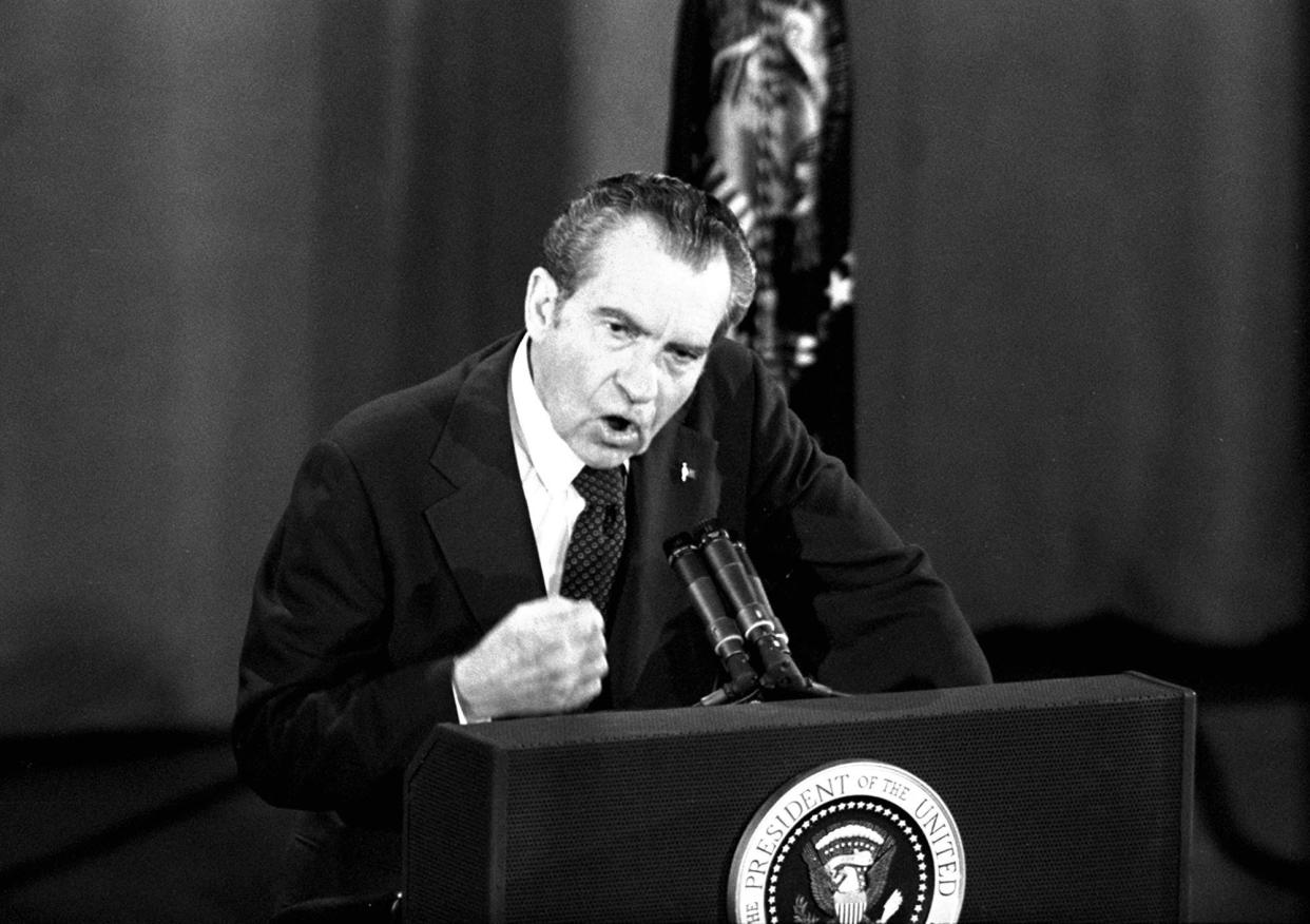President Richard Nixon pounds his fist on the podium as he answers a question during his televised appearance before questioners made up of members of the National Broadcasters Association in Houston, Texas, March 19, 1974.  President Nixon declared that dragging out Watergate drags down America.