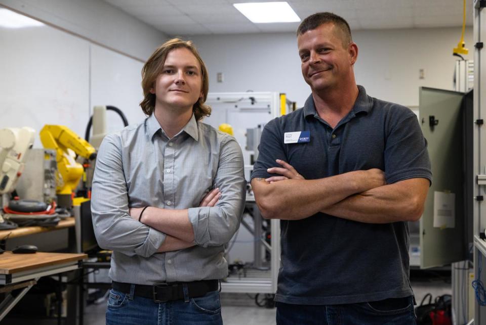 From left: Dalton Mayo, a fourth-semester Robotics student at the Texas State Technical College in Waco, stands with his father, Corey Mayo, who serves as the Lead Instructor for Robotics and Industrial Controls Technology inside their classroom on Oct. 24, 2022. Mayo decided to pursue a technical career path like his father.