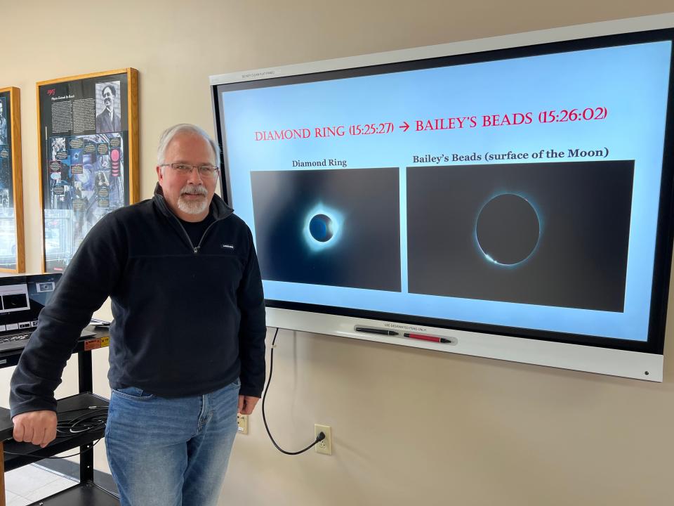 Professor of Physics and St. Michael's College's resident astrophysicist, Alain Brizard discusses what makes this total solar eclipse special and what else to look for in the sky. Pictured April 1, 2024 Brizard stands in front of images that show the diamond ring effect (left) and Baily's beads (right) which may be observable right before and right after totality on April 8.