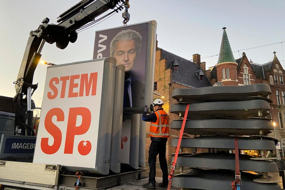 An eclection campaing poster of Geert Wilders' PVV party is removed in The Hague this morning (Copyright 2023 The Associated Press. All rights reserved)