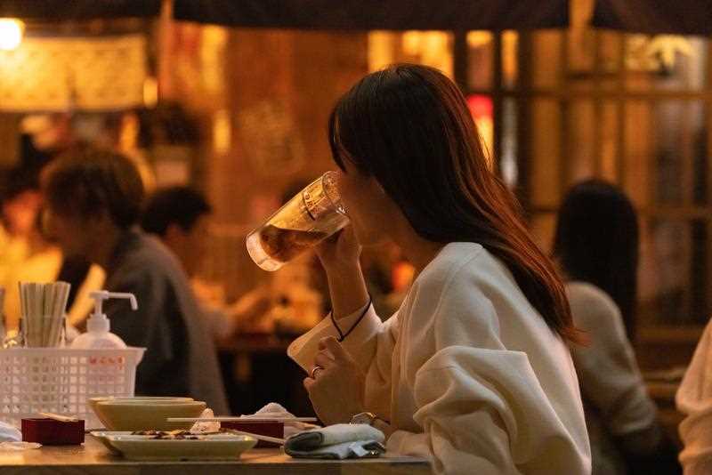 A woman drinks beer inside a restaurant at Miyashita Park in Shibuya, Tokyo.