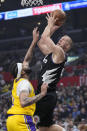Los Angeles Clippers center Mason Plumlee, right, shoots as Los Angeles Lakers forward Anthony Davis defends during the first half of an NBA basketball game Wednesday, Feb. 28, 2024, in Los Angeles. (AP Photo/Mark J. Terrill)