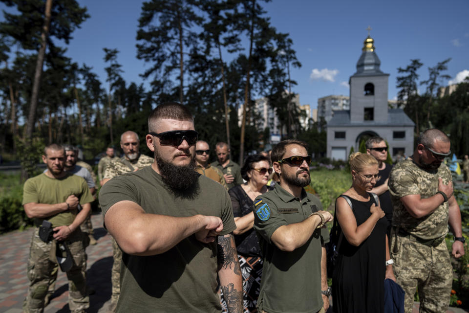 Ukrainian servicemen attend a farewell ceremony of their fallen comrade Nicholas Maimer, a U.S. citizen and Army veteran who was killed during fighting in Bakhmut against Russian forces, in Ukrajinka, Ukraine, Wednesday, July 19, 2023. (AP Photo/Evgeniy Maloletka)