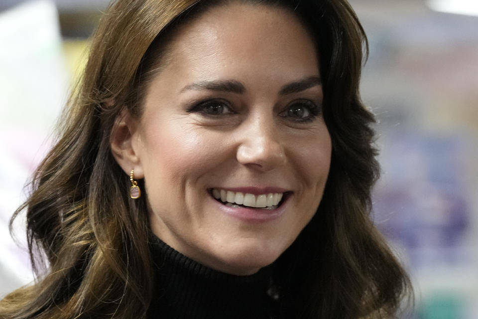 FILE - Kate, Princess of Wales smiles as she speaks to a woman during her visit to Sebby's Corner in north London on Nov. 24, 2023. Charles' illness comes at a awkward time, as his daughter in law, the Princess of Wales, has also had her own health issues, having recently been hospitalized for two weeks following abdominal surgery following at the private London clinic. The former Kate Middleton won't be returning to public duties until after Easter and that will prompt other members of the royal family to pick up the slack. (AP Photo/Frank Augstein, Pool)