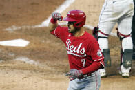 Cincinnati Reds' Eugenio Suarez (7) celebrates his two-run home run off Minnesota Twins pitcher J.A. Happ in the fourth inning of a baseball game, Monday, June 21, 2021, in Minneapolis. (AP Photo/Jim Mone)