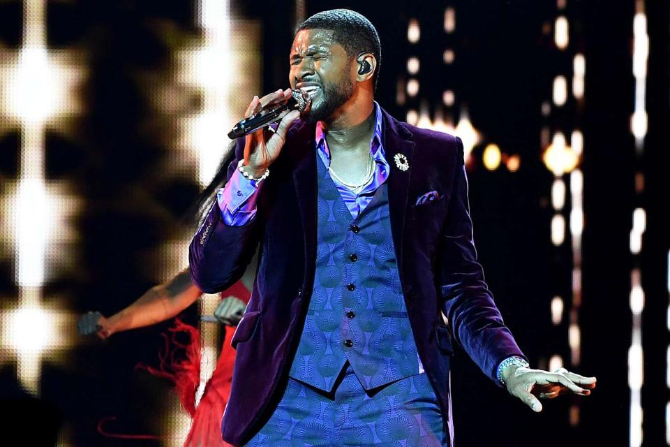<p>Denise Truscello/Getty</p> Usher performing in July 2022.