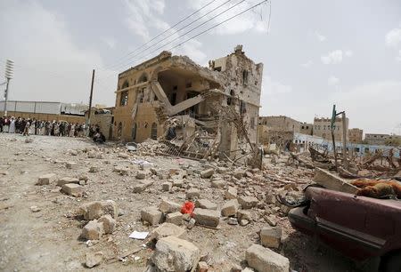 People gather at a site hit by a Saudi-led air strike in Yemen's capital Sanaa July 3, 2015. REUTERS/Khaled Abdullah