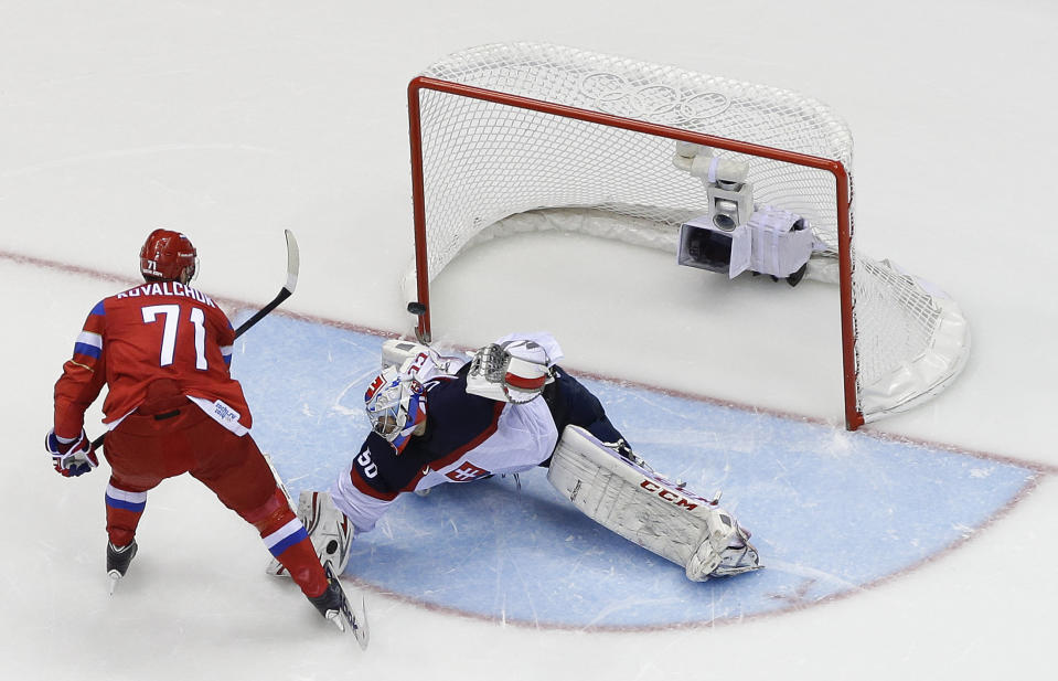 Russia forward Ilya Kovalchuk flips the puck past Slovakia goaltender Jan Laco to win a shootout during a men's ice hockey game at the 2014 Winter Olympics, Sunday, Feb. 16, 2014, in Sochi, Russia. Russia won 1-0. (AP Photo/Mark Humphrey )