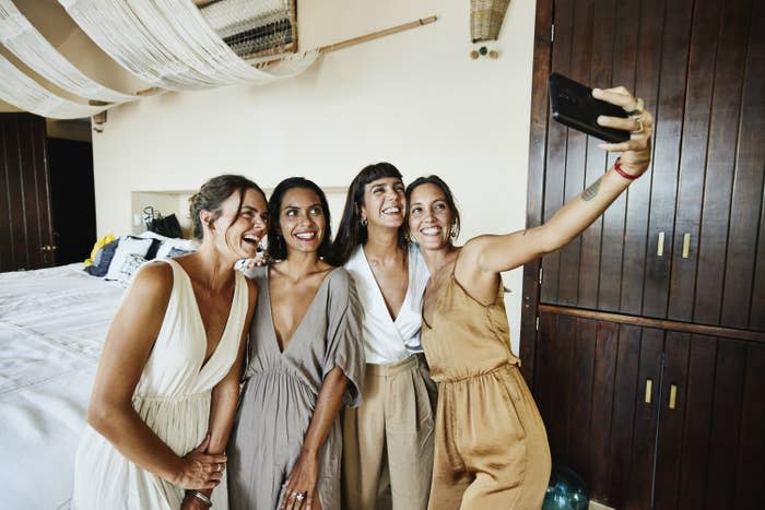 a bride taking a selfie picture with her bridesmaids
