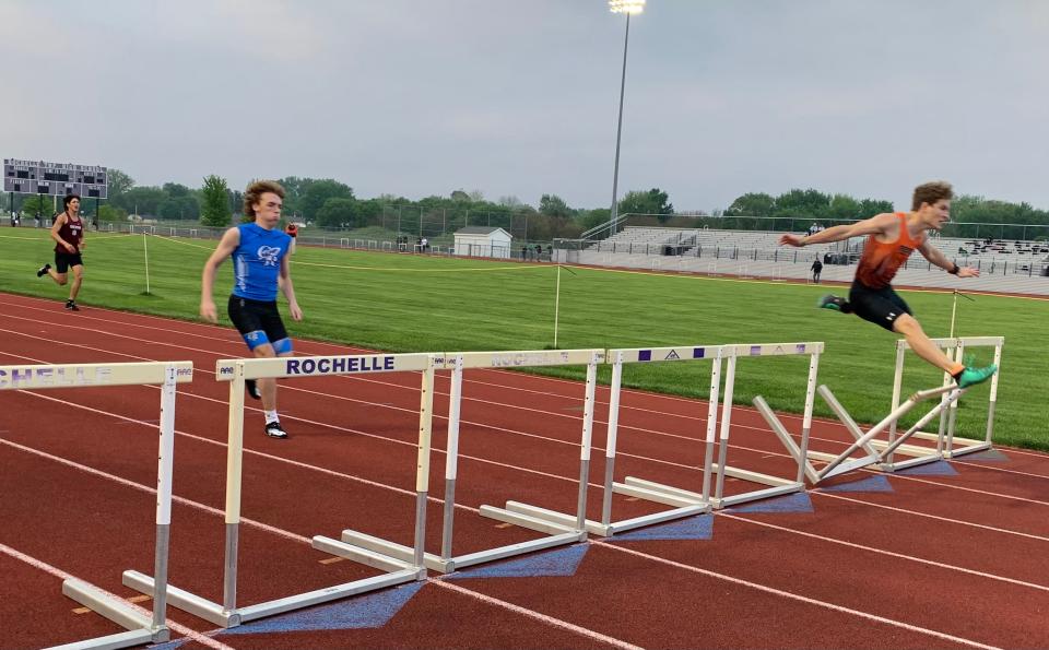 Freeport senior Bayley Pierce, right, hits the final hurdle of the 300-meter race at the Rochelle Sectional on Wednesday, May 18, 2022, but he stayed the course and qualified for state.